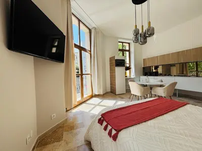 a bedroom with a bed with a flat screen tv at Le Sainte Rose Standing, Cannes center on foot in Cannes