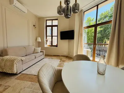 a living room with a table and a couch at Le Sainte Rose Standing, Cannes center on foot in Cannes