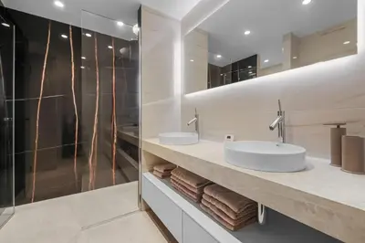 a bathroom with two sinks and a shower at REF 1998 - Cannes - Sea view apartment for rent in Cannes