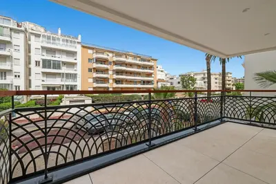 a balcony with a view of a city at REF 1998 - Cannes - Sea view apartment for rent in Cannes