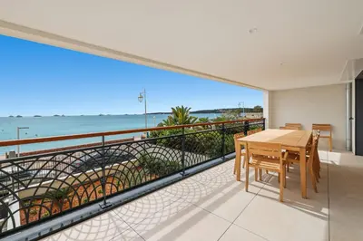 a balcony with a table and a view of the ocean at REF 1998 - Cannes - Sea view apartment for rent in Cannes