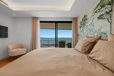 a bedroom with a bed with a view of the ocean at REF 1998 - Cannes - Sea view apartment for rent in Cannes
