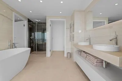a bathroom with two sinks and a bath tub at REF 1998 - Cannes - Sea view apartment for rent in Cannes