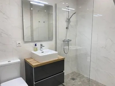 a white bathroom with a sink and a shower at Cannes proche Croisette - Studio moderne balcon in Cannes