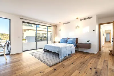 a bedroom with a bed with blue pillows at Villa Dream Cannes in Cannes