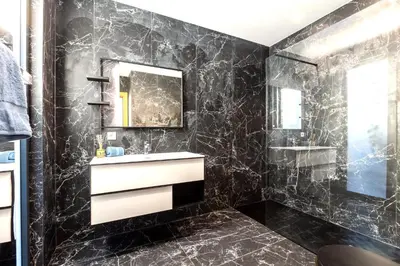 a black bathroom with a sink and a mirror at Villa Dream Cannes in Cannes