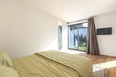 a bedroom with a bed and a large window at Villa Dream Cannes in Cannes