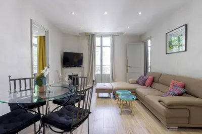a living room with a couch and a glass table at 13 Boulevard Carnot by Halldis in Cannes