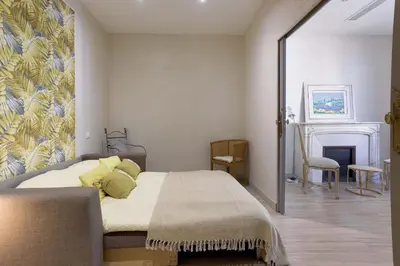 a bedroom with a bed and a fireplace at 13 Boulevard Carnot by Halldis in Cannes