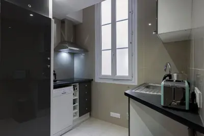 a small kitchen with a sink and a window at 13 Boulevard Carnot by Halldis in Cannes