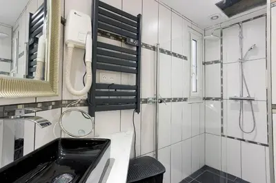 a bathroom with a sink and a mirror and a shower at 13 Boulevard Carnot by Halldis in Cannes