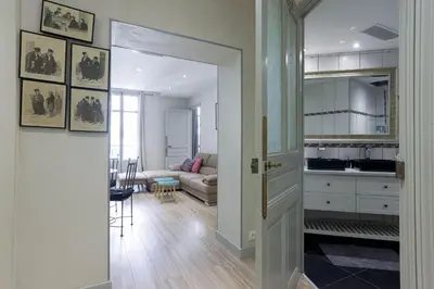 an open door to a living room with a couch at 13 Boulevard Carnot by Halldis in Cannes