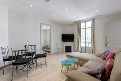 a living room with a couch and a table at 13 Boulevard Carnot by Halldis in Cannes