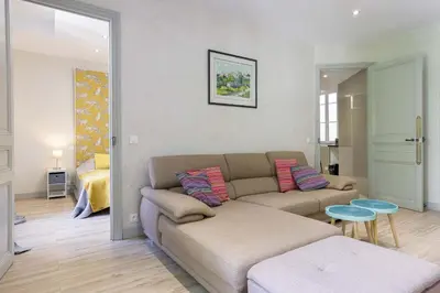 a living room with a couch and a table at 13 Boulevard Carnot by Halldis in Cannes
