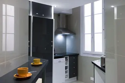 a kitchen with two yellow dishes on a counter at 13 Boulevard Carnot by Halldis in Cannes
