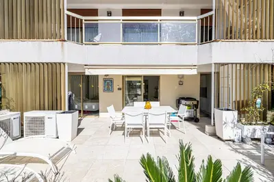 a patio with a table and chairs in a building at REF 1966 - Cannes city center in Cannes