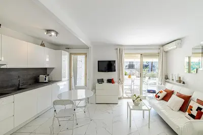 a white living room with a white couch and a table at REF 1966 - Cannes city center in Cannes