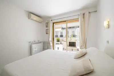 a white bedroom with a large bed and a window at REF 1966 - Cannes city center in Cannes