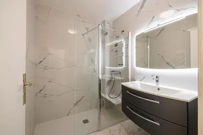 a bathroom with a shower and a sink and a mirror at REF 1966 - Cannes city center in Cannes
