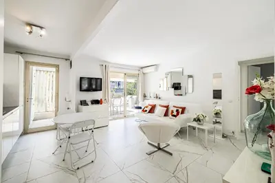 a white living room with a couch and a table at REF 1966 - Cannes city center in Cannes