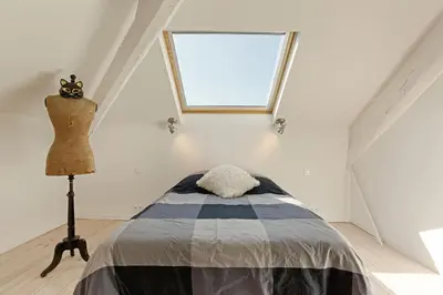 a bedroom with a bed and a dresser and a window at Aura Apartments by Halldis in Cannes