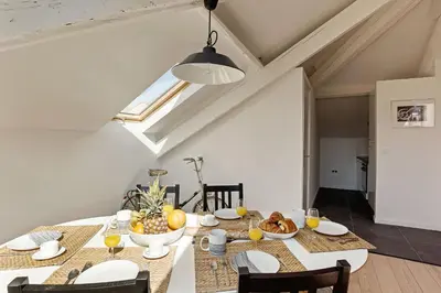 a dining room with a table with food on it at Aura Apartments by Halldis in Cannes