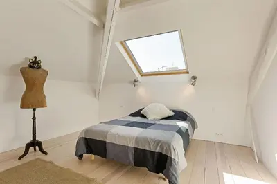 a bedroom with a bed and a window and a dresser at Aura Apartments by Halldis in Cannes