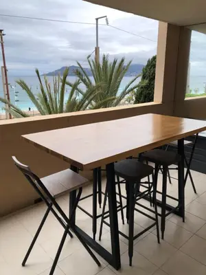 a table and chairs in front of a window at Charme in Cannes La Bocca