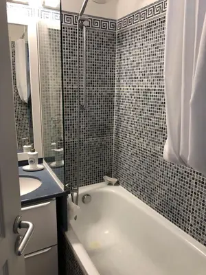 a bathroom with a tub and a sink and a shower at Charme in Cannes La Bocca