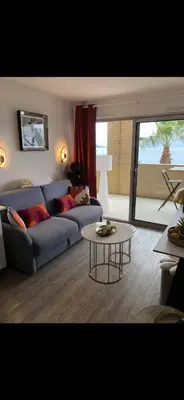 a living room with a couch and a table at Charme in Cannes La Bocca