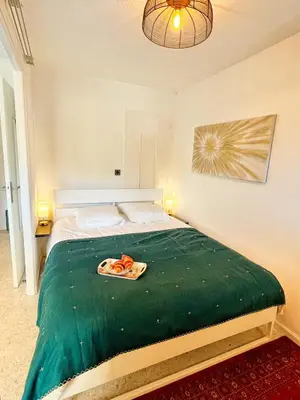 a bedroom with a bed with a tray of carrots on it at Cannes Breeze in Cannes