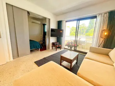 a living room with a couch and a room with a window at Cannes Breeze in Cannes