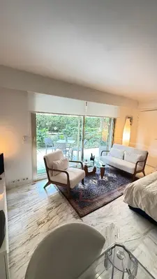 a living room with two chairs and a couch at Studio basse californie cannes in Cannes