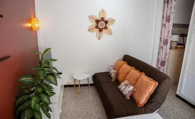 a brown couch with pillows in a living room at Very Quiet Palm Beach Studio Close Beach in Cannes