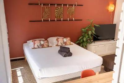 a bedroom with a large bed with white sheets at Very Quiet Palm Beach Studio Close Beach in Cannes