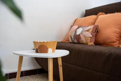 a table with a cup on it next to a couch at Very Quiet Palm Beach Studio Close Beach in Cannes