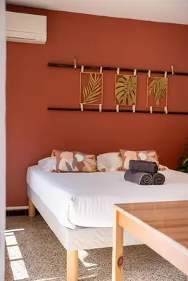 a bedroom with a large bed with a wall at Very Quiet Palm Beach Studio Close Beach in Cannes