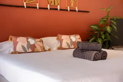 a bed with two pillows on top of it at Very Quiet Palm Beach Studio Close Beach in Cannes