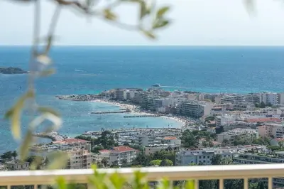 a view of a city with a beach and the ocean at REF 1969 - Cannes - Penthouse with panoramic sea view for rent in Cannes