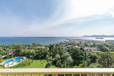 a view of the ocean from the balcony of a house at REF 1969 - Cannes - Penthouse with panoramic sea view for rent in Cannes