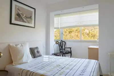 a bedroom with a bed and a chair and a window at REF 1969 - Cannes - Penthouse with panoramic sea view for rent in Cannes