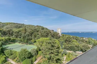 an aerial view of a tennis court on a hill at REF 1969 - Cannes - Penthouse with panoramic sea view for rent in Cannes