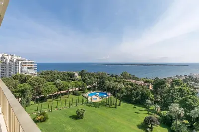 an aerial view of a park with a swimming pool and the ocean at REF 1969 - Cannes - Penthouse with panoramic sea view for rent in Cannes
