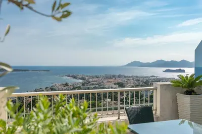 a balcony with a view of the ocean at REF 1969 - Cannes - Penthouse with panoramic sea view for rent in Cannes