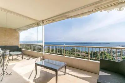 a balcony with a view of the ocean at REF 1969 - Cannes - Penthouse with panoramic sea view for rent in Cannes