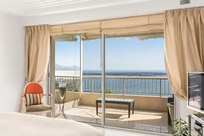 a bedroom with a view of the ocean at REF 1969 - Cannes - Penthouse with panoramic sea view for rent in Cannes