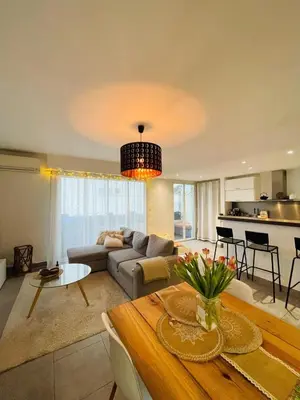 a living room with a couch and a table at Bel Appartement lumineux avec balcon in Le Cannet