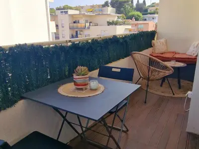 a small bedroom with a bed and a mirror at Bel Appartement lumineux avec balcon in Le Cannet
