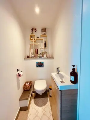 a bathroom with a toilet and a sink at Bel Appartement lumineux avec balcon in Le Cannet
