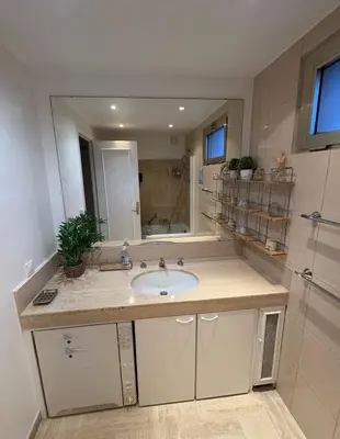 a bathroom with a sink and a large mirror at Appartement vue & front de mer, piscines, 55M2 2Pièces in Cannes